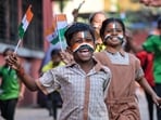School students celebrate Republic Day 2026 with tricolour-painted faces and beaming smiles.(Raju Shinde)