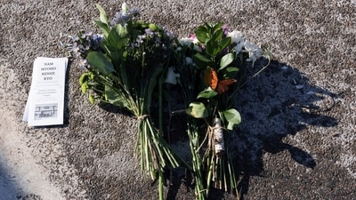 Flowers lie on the ground near the site where the 37-year-old demonstrator was shot dead by federal agents on Saturday. The shooting fueled nationwide protests against Immigration and Customs Enforcement agents. (Tim Evans/REUTERS)