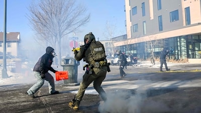 A federal agent aims his weapon at a demonstrator after protests broke out across the United States when an ICE agent shot an anti-immigration protester dead in Minneapolis. The Trump administration has sent a reported 3,000 federal agents into the area, with more on the way. (Brandon Bell/Getty Images via AFP) A federal agent aims his weapon at a demonstrator after protests broke out across the United States when an ICE agent shot an anti-immigration protester dead in Minneapolis. The Trump administration has sent a reported 3,000 federal agents into the area, with more on the way. (Brandon Bell/Getty Images via AFP)