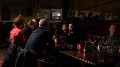 Residents of Nuuk sit at a table in a local bar which was left without electricity following the massive power outage that hit the Greenlandic capital city Nuuk on Saturday. (Marko Djurica/REUTERS)