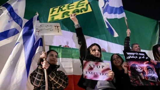 Israelis hold signs and flags, as they rally against the government of Iran, in Holon, Israel, January 24, 2026.