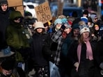 Protesters against Immigration and Customs Enforcement (ICE) march through the streets of downtown Minneapolis, Minnesota, on January 25, 2026. (Photo by ROBERTO SCHMIDT / AFP)