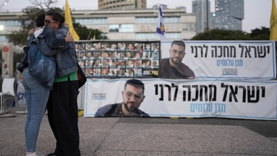 Two women embrace next to a banner with a photo of Ran Gvili after the announcement that the hostage, whose remains were the last to be recovered from Gaza, had been identified, in a plaza known as Hostages Square in Tel Aviv, Israel, Monday, Jan. 26, 2026. (AP) Two women embrace next to a banner with a photo of Ran Gvili after the announcement that the hostage, whose remains were the last to be recovered from Gaza, had been identified, in a plaza known as Hostages Square in Tel Aviv, Israel, Monday, Jan. 26, 2026. (AP)
