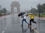 People enjoy the rain at Kartavya Path, in New Delhi on Tuesday. People enjoy the rain at Kartavya Path, in New Delhi on Tuesday.