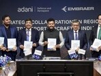 Civil aviation minister Ram Mohan Naidu Kinjarapu (middle) during an MoU exchange between Adani Group and Brazilian aerospace major Embraer on Tuesday. (@RamMNK)