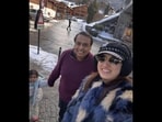 Mukesh Ambani and his grandkid posing for a fan. 