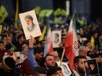 Hizbullah supporters hold portraits of Iran's Supreme Leader Ayatollah Ali Khamenei during a rally to show their solidarity with Iran, in the southern suburb of Beirut on January 26, 2026. 