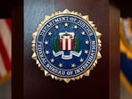 An FBI seal is displayed on a podium before a news conference in Portland, Ore