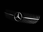 The Mercedes-Benz logo is pictured on the hood of a car.