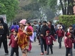 Parents escorting their wards from a school in Sector 28, Chandigarh, on Wednesday after the bomb scare. (Ravi Kumar/HT)(HT_PRINT)