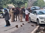 Police and forensic experts at the firing site near the Mohali senior superintendent of police’s office in the District Administrative Complex on Wednesday. (Sanjeev Sharma/HT)