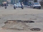The potholed Gill road in the city. Several roads await recarpeting in Ludhiana. (Gurpreet Singh/HT)