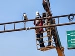 Workers installing surveillance cameras on Mall road in Bathinda. (Sanjeev Kumar/HT) Workers installing surveillance cameras on Mall road in Bathinda. (Sanjeev Kumar/HT)