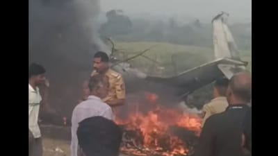 Police officials seen at the site of the crash in Baramati where Ajit Pawar's aircraft was reduced to flames. All people onboard the aircraft were confirmed dead by DGCA. (Screengrab/Hindustan Times)