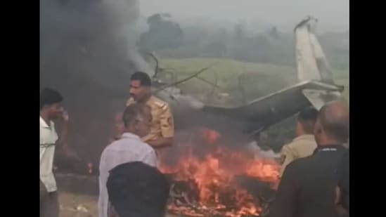 Police officials seen at the site of the crash in Baramati where Ajit Pawar's aircraft was reduced to flames. All people onboard the aircraft were confirmed dead by DGCA.(Screengrab/Hindustan Times)