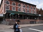 A man passes the Chabad-Lubavitch World Headquarters in the Crown Heights neighborhood of Brooklyn (AP Photo/Mark Lennihan, File)