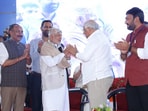 Gujarati folk artist Mir Haji Kasam Rathod with chief minister Bhupendra Patel. (X)