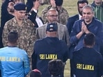 Pakistan's Cricket Board Chairman Mohsin Naqvi (togestures while speaking with Sri Lanka's players. 