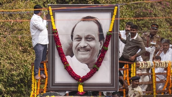 A garland is hung on a portrait of Ajit Pawar when his body were brought to Vidya Pratishthan college ground for his funeral at Baramati on Thursday.(PTI)