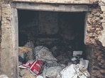 An arched niche in the building below is filled with discarded plastic bags, sacks, and broken bricks. (Mayank Austen Soofi)