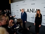 US President Donald Trump, left, and First Lady Melania Trump speak to members of the media while arriving for the world premiere 'Melania' at the Kennedy Center in Washington, DC.
