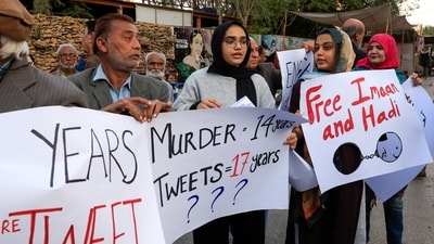 Activists, lawyers and journalists carry posters as they gather in solidarity with human rights activist and lawyer, Imaan Mazari and her husband after court convicted them on charges of anti-state social media posts. (Reuters)