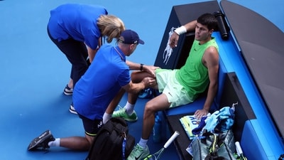 Spain's Carlos Alcaraz gets medical attention during his men's singles semi-final match against Germany's Alexander Zverev. (AFP) Spain's Carlos Alcaraz gets medical attention during his men's singles semi-final match against Germany's Alexander Zverev. (AFP)