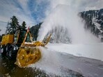 A heavy duty machinery removes snow from Mughal Road, that connects Shopian district with Poonch-Rajouri, after fresh snowfall, in Shopian district, Jammu and Kashmir, on Friday. (PTI)