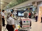 Airport health authorities wearing protective masks monitor passengers from international flights 