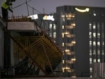 A labourer works atop an under-construction metro site near the Amazon India headquarters in Bengaluru (AFP)