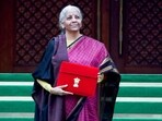 Union Finance Minister Nirmala Sitharaman shows the budget tablet as she arrives at the Parliament House.