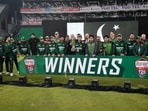 Pakistani players and official pose for photograph with the trophy after winning the T20 series against Australia.