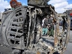 Bystanders walk past a burnt vehicle along a road on the outskirts of Quetta on February 1, 2026 a day after an attack by Baloch separatists. (AFP) Bystanders walk past a burnt vehicle along a road on the outskirts of Quetta on February 1, 2026 a day after an attack by Baloch separatists. (AFP)