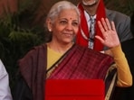 Nirmala Sitharaman saree: Finance Minister Nirmala Sitharaman waves while posing with officials before leaving her office to present the union budget on February 1.