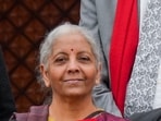 Finance Minister Nirmala Sitharaman shows the digital tablet, enclosed in a traditional red 'bahi-khata' style pouch, at the Parliament premises before presenting of the �Union Budget 2026-27�, in New Delhi, Sunday, Feb. 1, 2026.