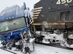 Dramatic footage shows semi-truck stuck on tracks struck by train in Gastonia as historic winter bomb cyclone batters North Carolina