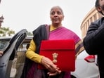 Finance minister Nirmala Sitharaman shows the digital tablet, enclosed in a traditional red 'bahi-khata' style pouch, at Parliament 