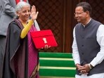Finance minister Nirmala Sitharaman shows the digital tablet, enclosed in a traditional red 'bahi-khata' style pouch, at Parliament premises before the presentation of the Union Budget 2026-27