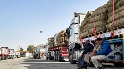 Truck drivers wait next to their vehicles which are transporting humanitarian aid, before entering through the Egyptian side of the Rafah border crossing with the Gaza Strip in Egypt. Aid in Gaza has been in a dire state due to Israel's bloclade since th war broke out in 2023. Despite the first stages of a ceasefire with Hamas, Israel has maintain strict aid bloackades, plunging Gaza into a state of famine. (AFP)