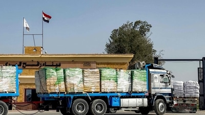 Trucks transporting humanitarian aid enter through the Egyptian side of the Rafah border after two years of closure and bloackade from Israeli forces (AFP)