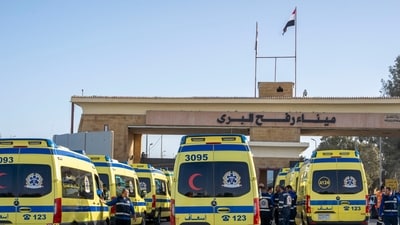 Ambulances line up to enter the Egyptian gate of the Rafah crossing on the way to the Gaza Strip. (AP)