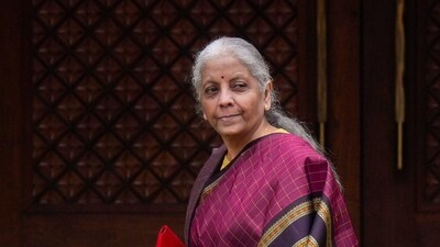 New Delhi: Finance Minister Nirmala Sitharaman with the digital tablet, enclosed in a traditional red 'bahi-khata' style pouch, at the Parliament premises before the presentation of the �Union Budget 2026-27�, in New Delhi, Sunday, Feb. 1, 2026. (PTI Photo/Shahbaz Khan)(PTI02_01_2026_000069A) (PTI) New Delhi: Finance Minister Nirmala Sitharaman with the digital tablet, enclosed in a traditional red 'bahi-khata' style pouch, at the Parliament premises before the presentation of the �Union Budget 2026-27�, in New Delhi, Sunday, Feb. 1, 2026. (PTI Photo/Shahbaz Khan)(PTI02_01_2026_000069A) (PTI)