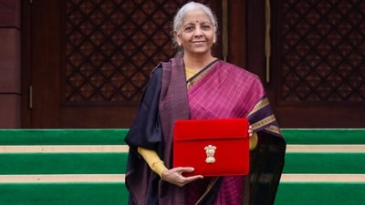 Finance Minister Nirmala Sitharaman shows the digital tablet, enclosed in a traditional red 'bahi-khata' style pouch, at the Parliament premises. (PTI) Finance Minister Nirmala Sitharaman shows the digital tablet, enclosed in a traditional red 'bahi-khata' style pouch, at the Parliament premises. (PTI)