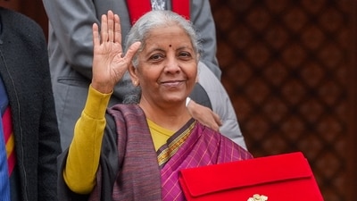 Finance Minister Nirmala Sitharaman shows the digital tablet, enclosed in a traditional red 'bahi-khata' style pouch, at the Parliament premises before presenting of the Union Budget 2026-27, in New Delhi. (PTI Photo/Ravi Choudhary) Finance Minister Nirmala Sitharaman shows the digital tablet, enclosed in a traditional red 'bahi-khata' style pouch, at the Parliament premises before presenting of the Union Budget 2026-27, in New Delhi. (PTI Photo/Ravi Choudhary)