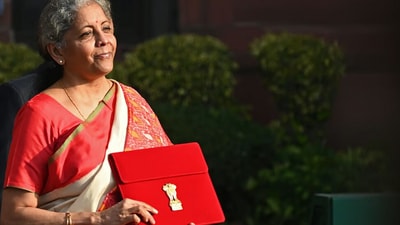 A bold choice in red and off-white, Nirmala Sitharaman's Pochampally Ikat saree from 2021 featured geometric patterns typical of Bhoodan Pochampally in Telangana. The vibrant border added a modern touch to the traditional 'Silk City' weave. (File Photo/ AFP) A bold choice in red and off-white, Nirmala Sitharaman's Pochampally Ikat saree from 2021 featured geometric patterns typical of Bhoodan Pochampally in Telangana. The vibrant border added a modern touch to the traditional 'Silk City' weave. (File Photo/ AFP)