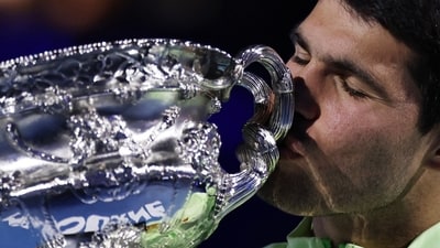 Carlos Alcaraz celebrates with the trophy after winning the Australian Open. (REUTERS)