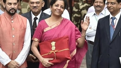 On her first budget day in 2019, the finance minister made headlines not just for her pink Mangalagiri silk saree with a gold border, but for replacing the colonial-era briefcase with the traditional Bahi-Khata (ledger) wrapped in red cloth. (File Photo/ PTI) On her first budget day in 2019, the finance minister made headlines not just for her pink Mangalagiri silk saree with a gold border, but for replacing the colonial-era briefcase with the traditional Bahi-Khata (ledger) wrapped in red cloth. (File Photo/ PTI)