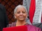 Finance Minister Nirmala Sitharaman shows the digital tablet, enclosed in a traditional red 'bahi-khata' style pouch, at the Parliament premises before presenting of the Union Budget 2026-27, in New Delhi, Sunday, Feb. 1, 2026. Finance Minister Nirmala Sitharaman shows the digital tablet, enclosed in a traditional red 'bahi-khata' style pouch, at the Parliament premises before presenting of the Union Budget 2026-27, in New Delhi, Sunday, Feb. 1, 2026.