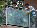 Forensic team members remove a shattered glass pane from the balcony of filmmaker Rohit Shetty after unidentified persons opened fire at his multi-storey residence, at Juhu. (PTI Photo) Forensic team members remove a shattered glass pane from the balcony of filmmaker Rohit Shetty after unidentified persons opened fire at his multi-storey residence, at Juhu. (PTI Photo)