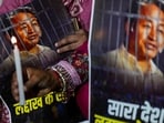 Agitators hold posters and a candle during a protest by AAP over the arrest of climate activist Sonam Wangchuk, at Jantar Mantar, in New Delhi.